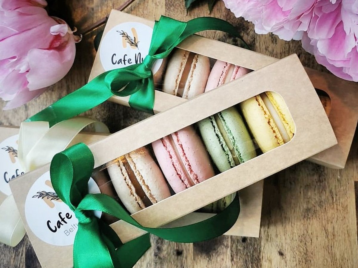Kraft boxes of Café Nua Belturbet macarons tied with green ribbon